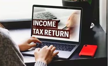 ITR Filing 2025: Person filing income tax return online on laptop in 2025